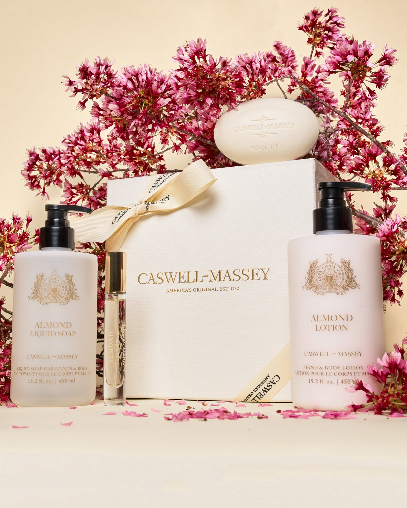 Caswell-Massey Mother's Day Luxe Gift Set in Almond. Featuring Almond Bar Soap, Almond Lotion (15.2oz), Almond Body Wash (15.2oz), and Almond Eau de Toilette (7.5ml) all presented in cream gift box with cream ribbon.